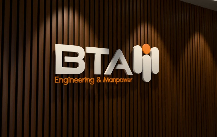 BTA Engineering & Manpower logo as built-up 3D letters on a walnut slat wall in a reception area