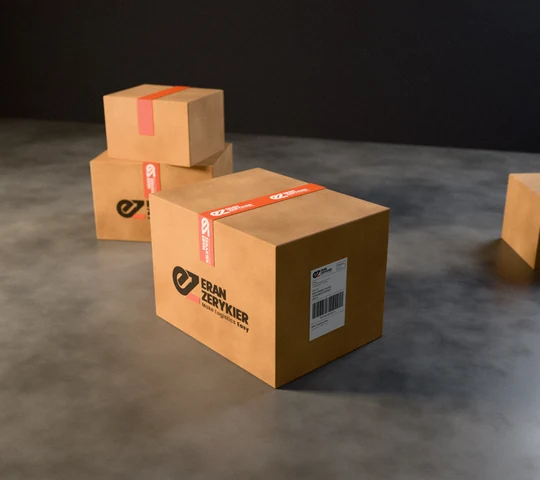 Eran Zerykier identity printed on corrugated shipping boxes, with branded packing tape and a shipping label